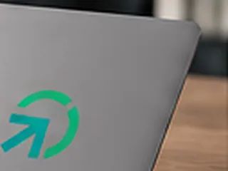 Concept rendering: a PWM Pathway arrow sticker on a laptop lid.